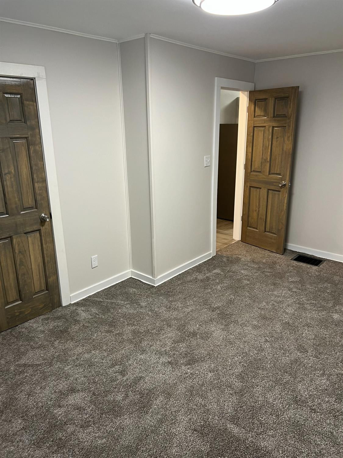 3863 Delaware Street Gary, IN 46409 - Photo 25 of 49 an empty room with sliding door and wooden door