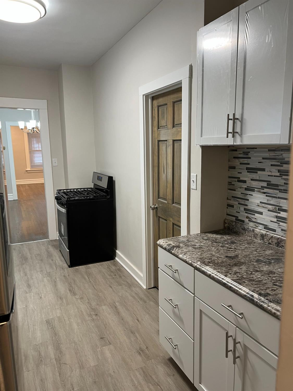 3863 Delaware Street Gary, IN 46409 - Photo 27 of 49 a kitchen with stainless steel appliances granite countertop a refrigerator and a sink