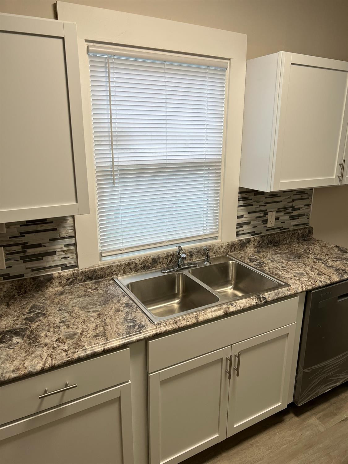 3863 Delaware Street Gary, IN 46409 - Photo 30 of 49 a kitchen with granite countertop a sink and a wooden cabinets