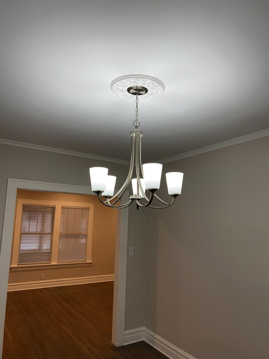 3863 Delaware Street Gary, IN 46409 - Photo 33 of 49 a view of a room with a hanging light and hardwood