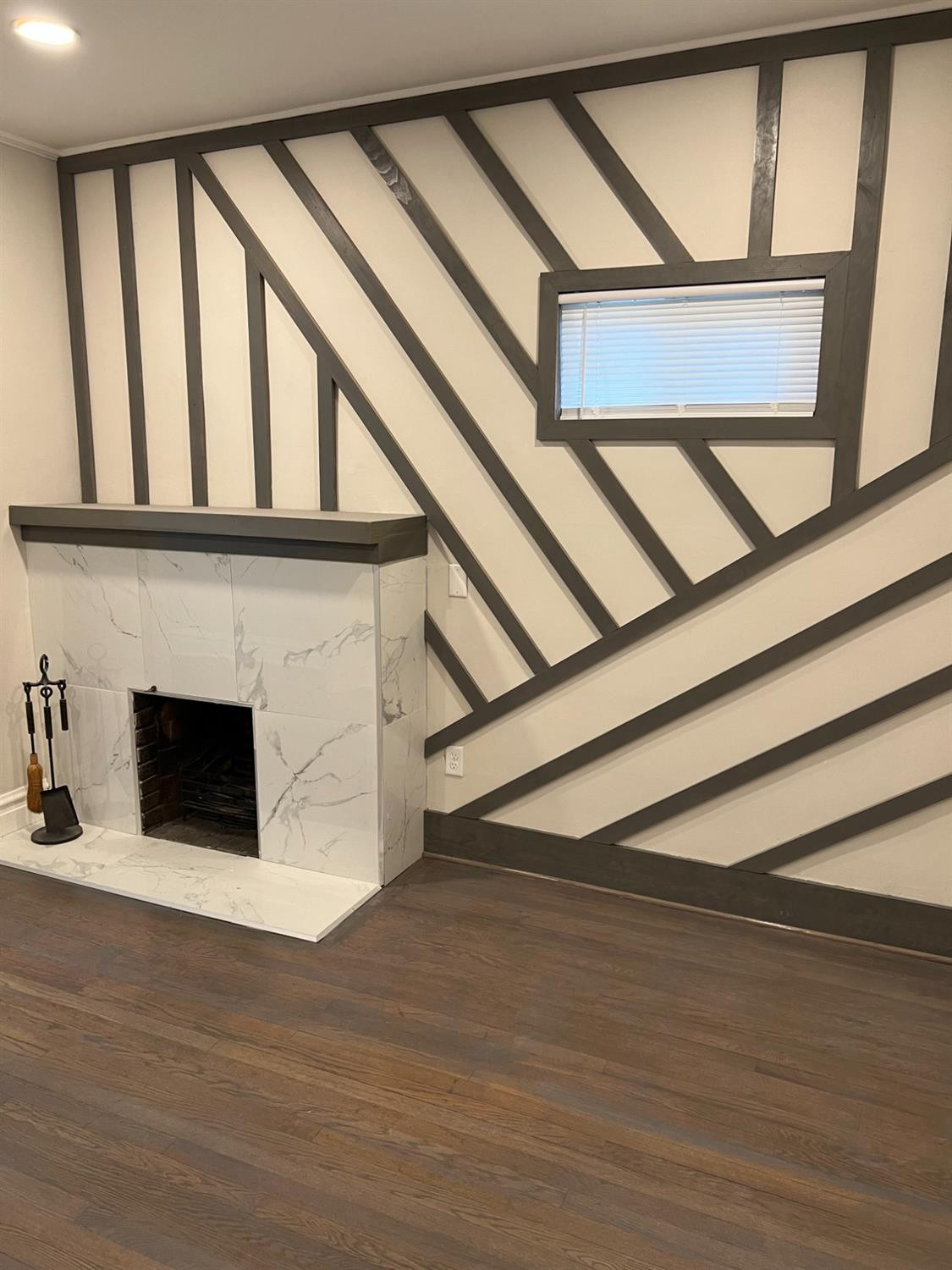 3863 Delaware Street Gary, IN 46409 - Photo 36 of 49 a view of an empty room with wooden floor and a fireplace