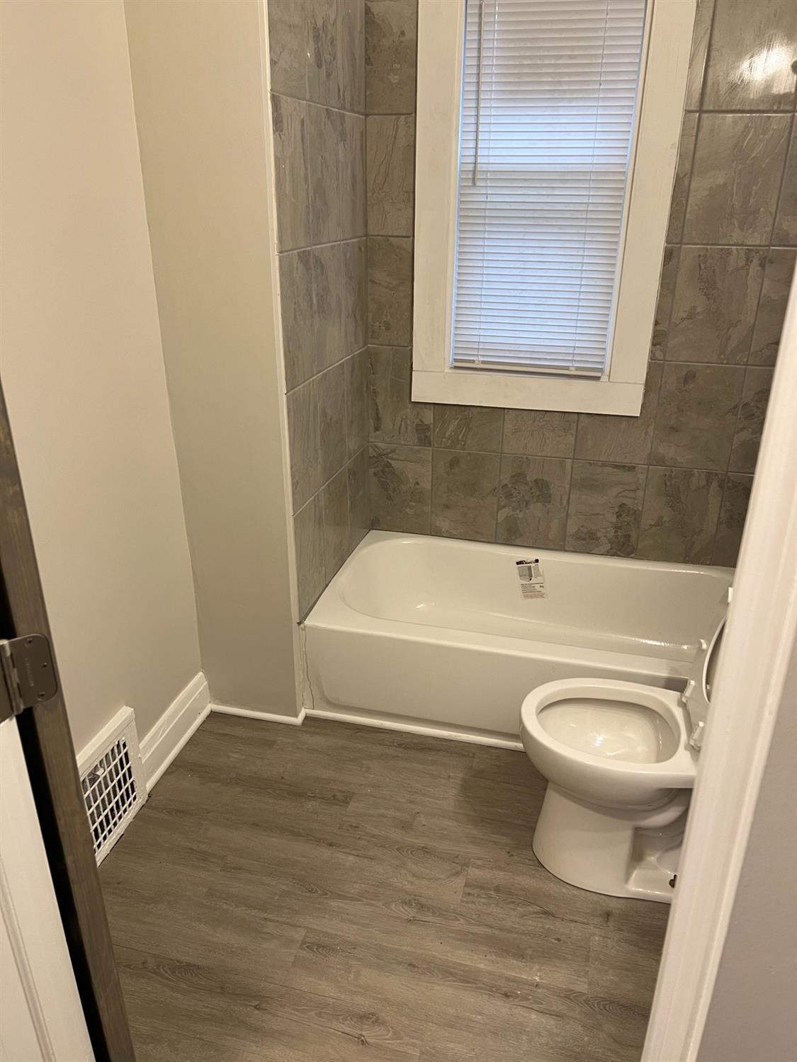 3863 Delaware Street Gary, IN 46409 - Photo 44 of 49 a bathroom with a toilet and a bathtub