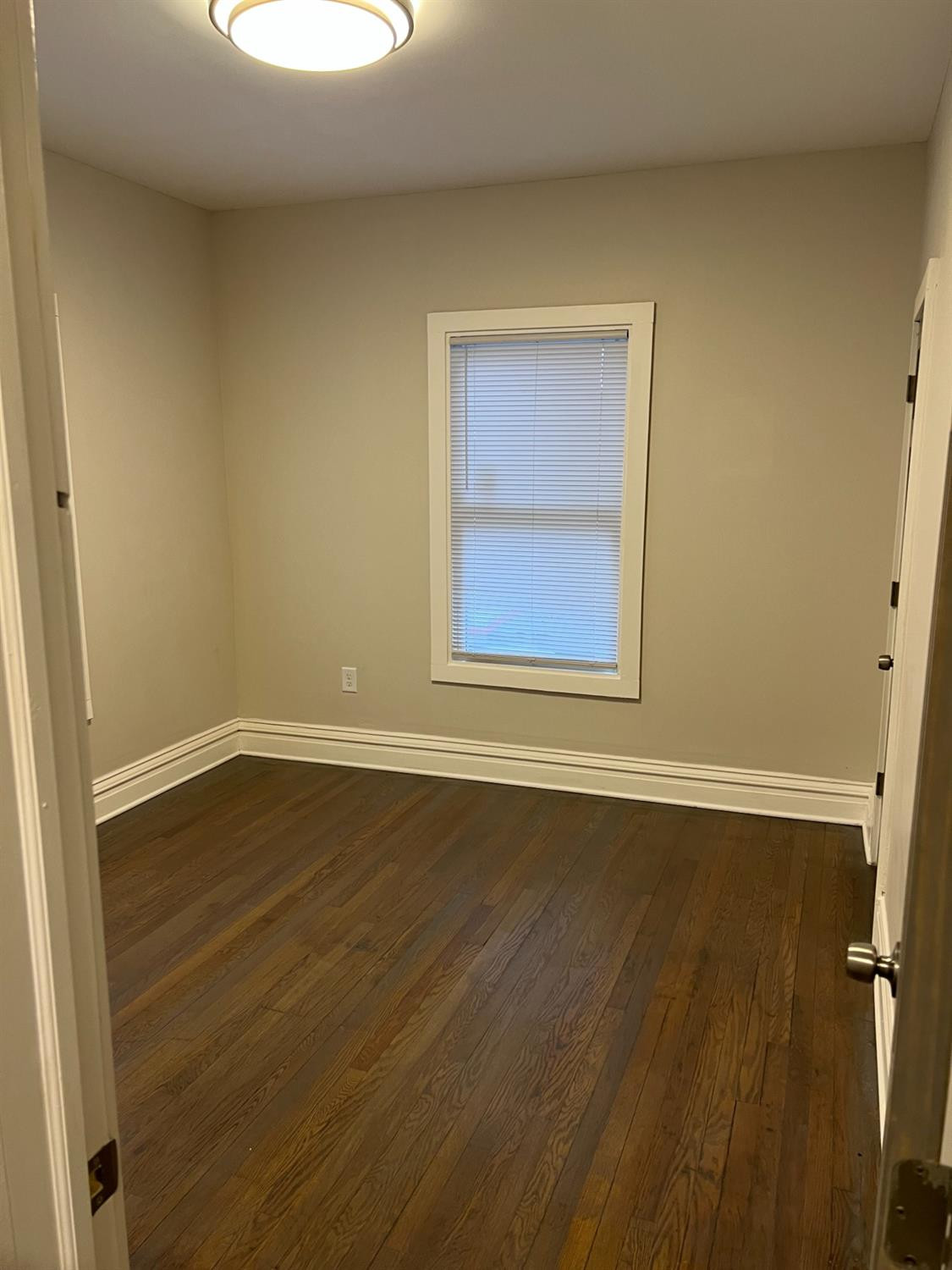 3863 Delaware Street Gary, IN 46409 - Photo 45 of 49 a view of an empty room with wooden floor and a window
