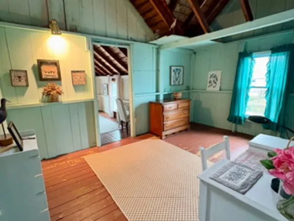 a bedroom with a bed and a dresser