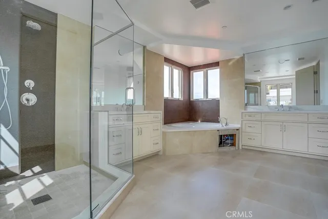 a view of a spacious bathroom with a tub shower and mirror