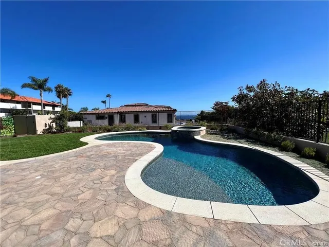 a view of a swimming pool with a yard