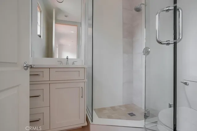 a bathroom with a shower sink and mirror