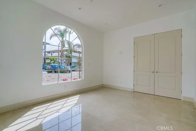 an empty room with windows and outdoor view