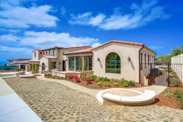 a view of a backyard with plants and lake view