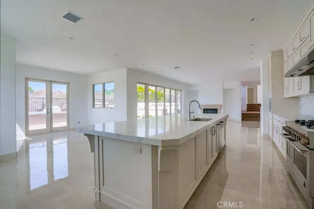 a kitchen with stainless steel appliances granite countertop a sink and stove