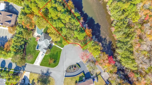 an aerial view of a house with a yard and garden