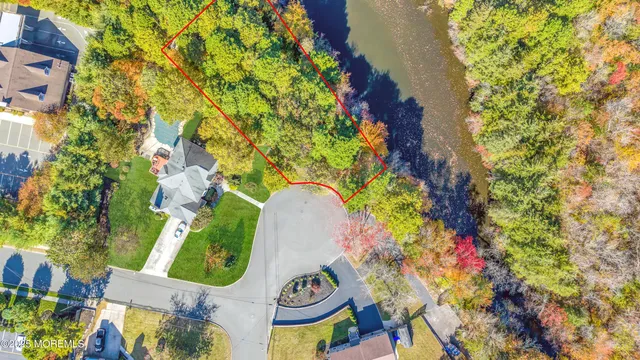 an aerial view of a house with a yard and garden