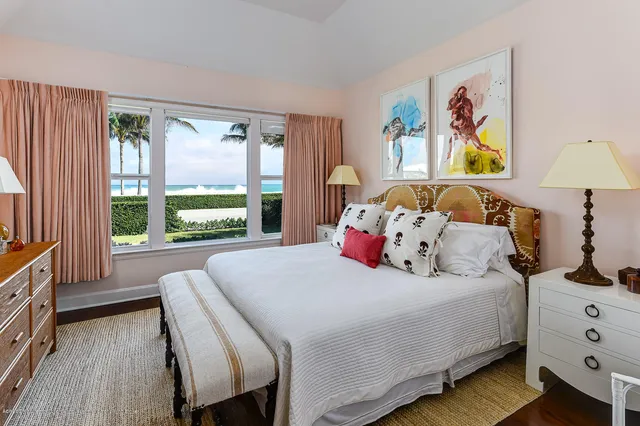 a bedroom with a bed a couch and a window