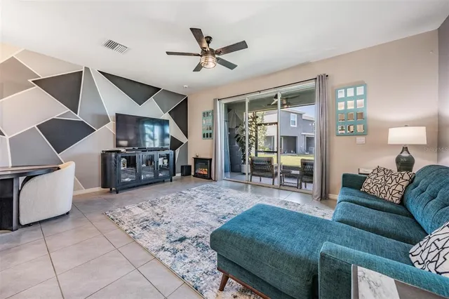 a living room with furniture and kitchen view