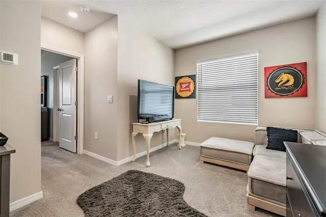 a bedroom with a bed and a tv on the dresser