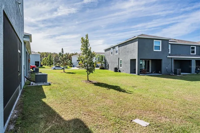 an aerial view of a house with a yard
