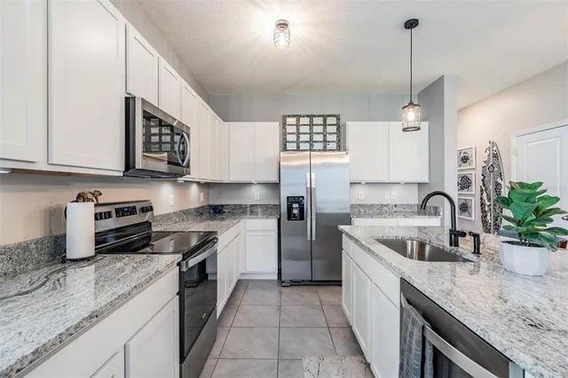 a kitchen with granite countertop kitchen island cabinets and appliances