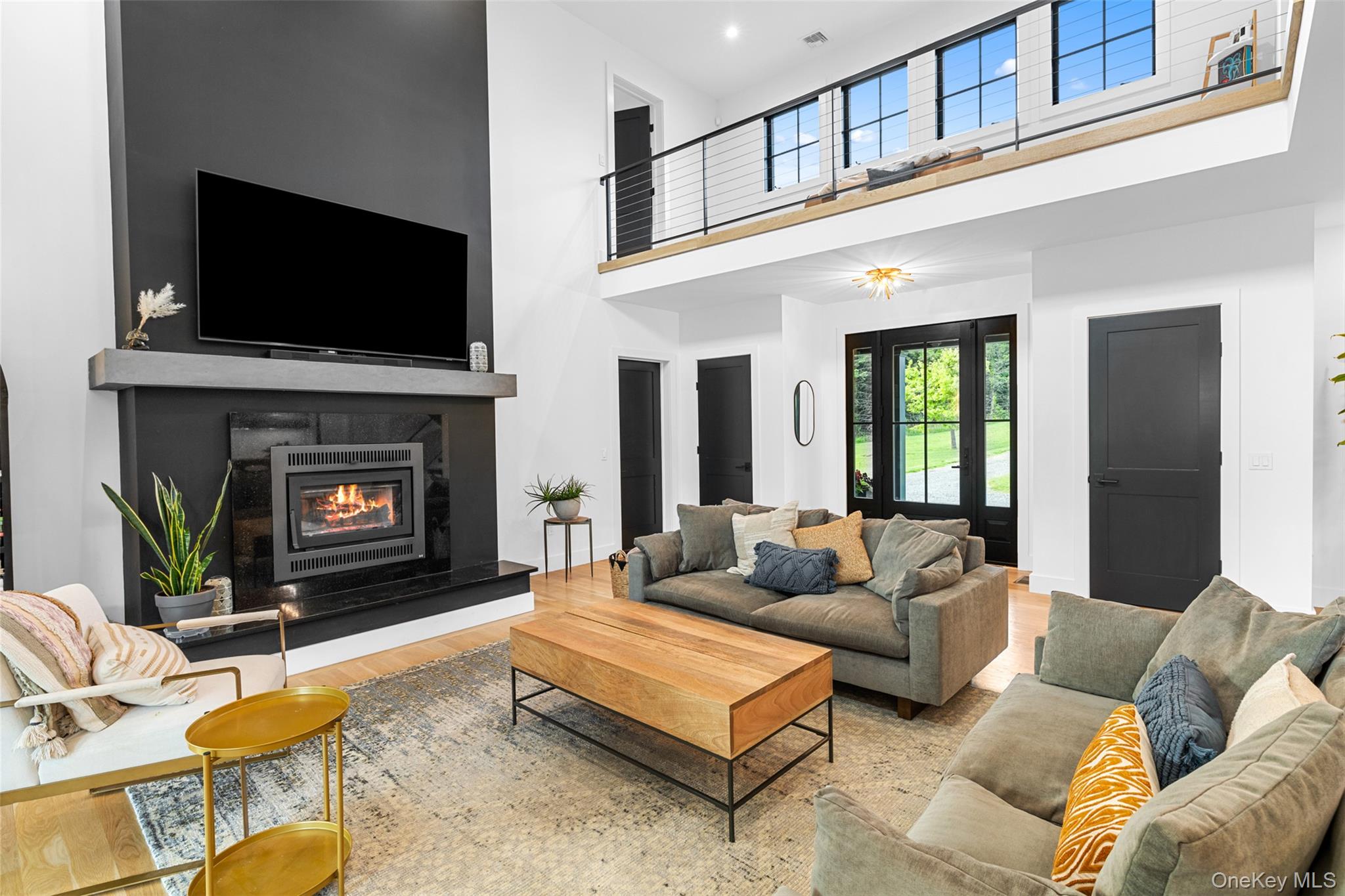 36 Spruce Lane Poughkeepsie, NY 12603 - Photo 10 of 33 Living area featuring a towering ceiling, wood finished floors, a glass covered fireplace, and recessed lighting