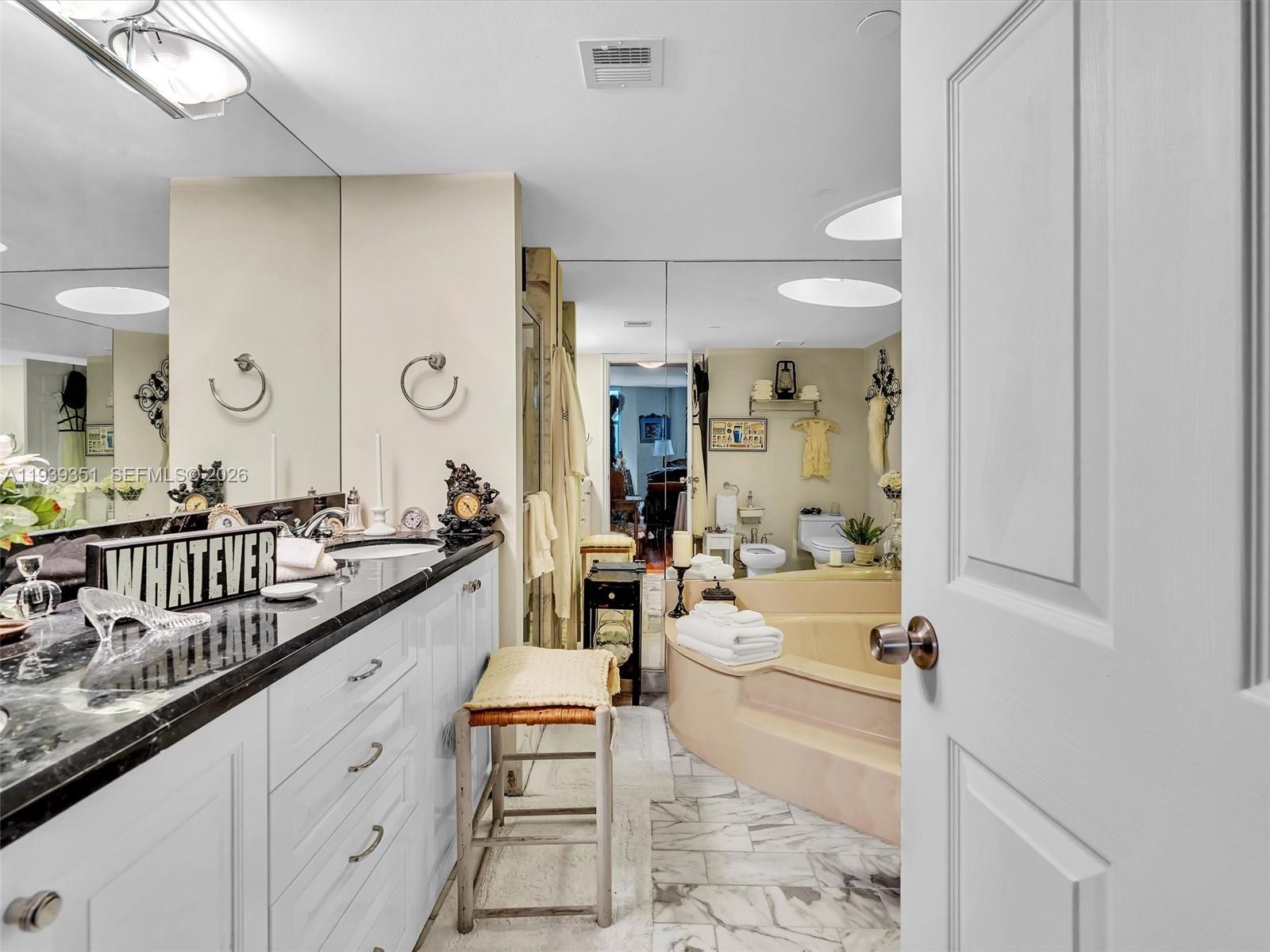 2000 Towerside Terrace, Unit 1806 Miami, FL 33138 - Photo 24 of 58 a large bathroom with a double vanity sink and a mirror