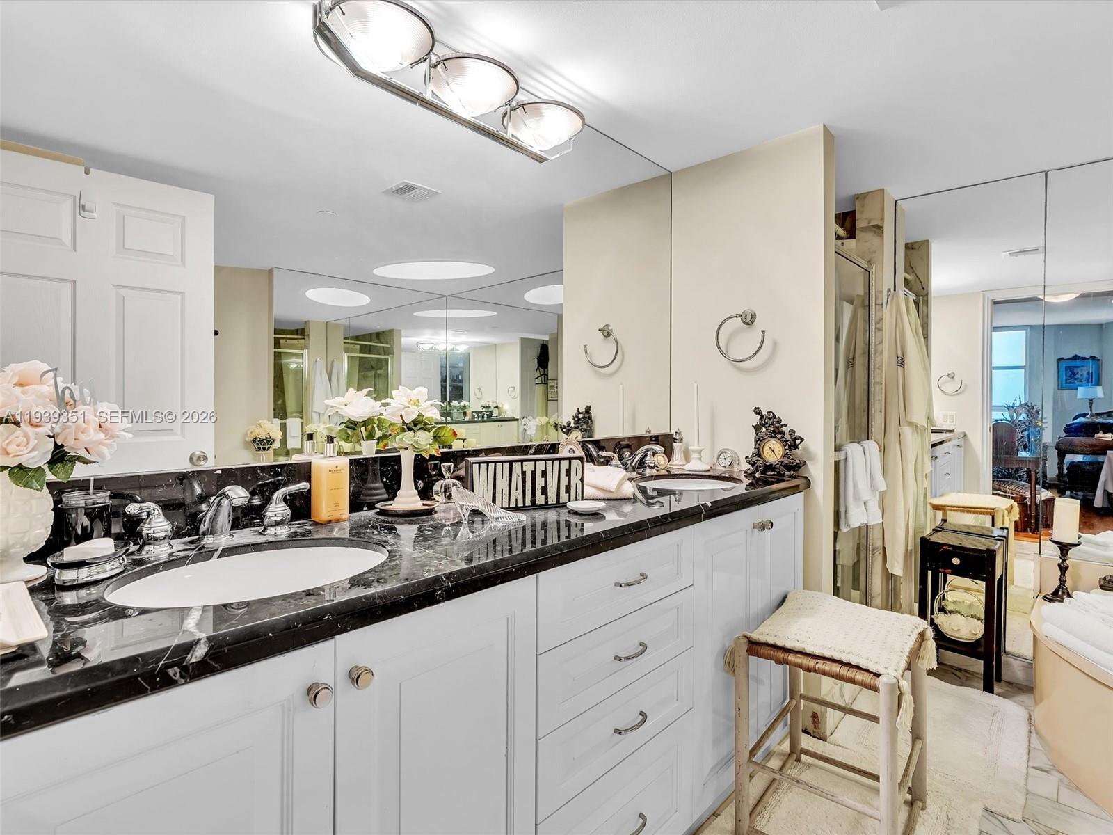 2000 Towerside Terrace, Unit 1806 Miami, FL 33138 - Photo 25 of 58 a large bathroom with a double vanity sink and a mirror
