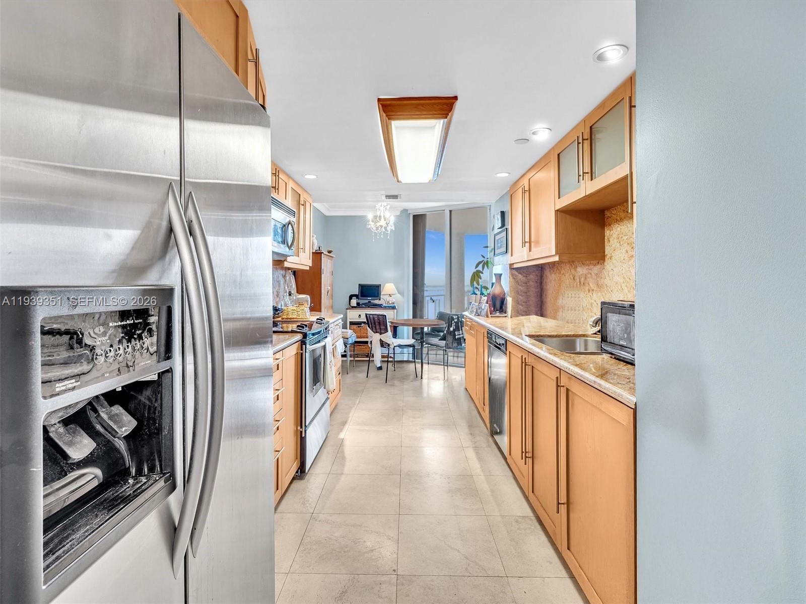 2000 Towerside Terrace, Unit 1806 Miami, FL 33138 - Photo 32 of 58 a kitchen with stainless steel appliances granite countertop a refrigerator and a sink