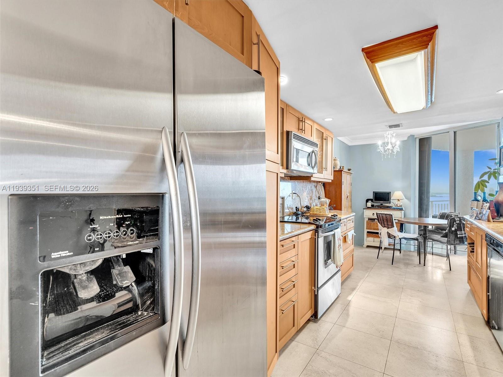 2000 Towerside Terrace, Unit 1806 Miami, FL 33138 - Photo 33 of 58 a kitchen with stainless steel appliances granite countertop a refrigerator and a stove