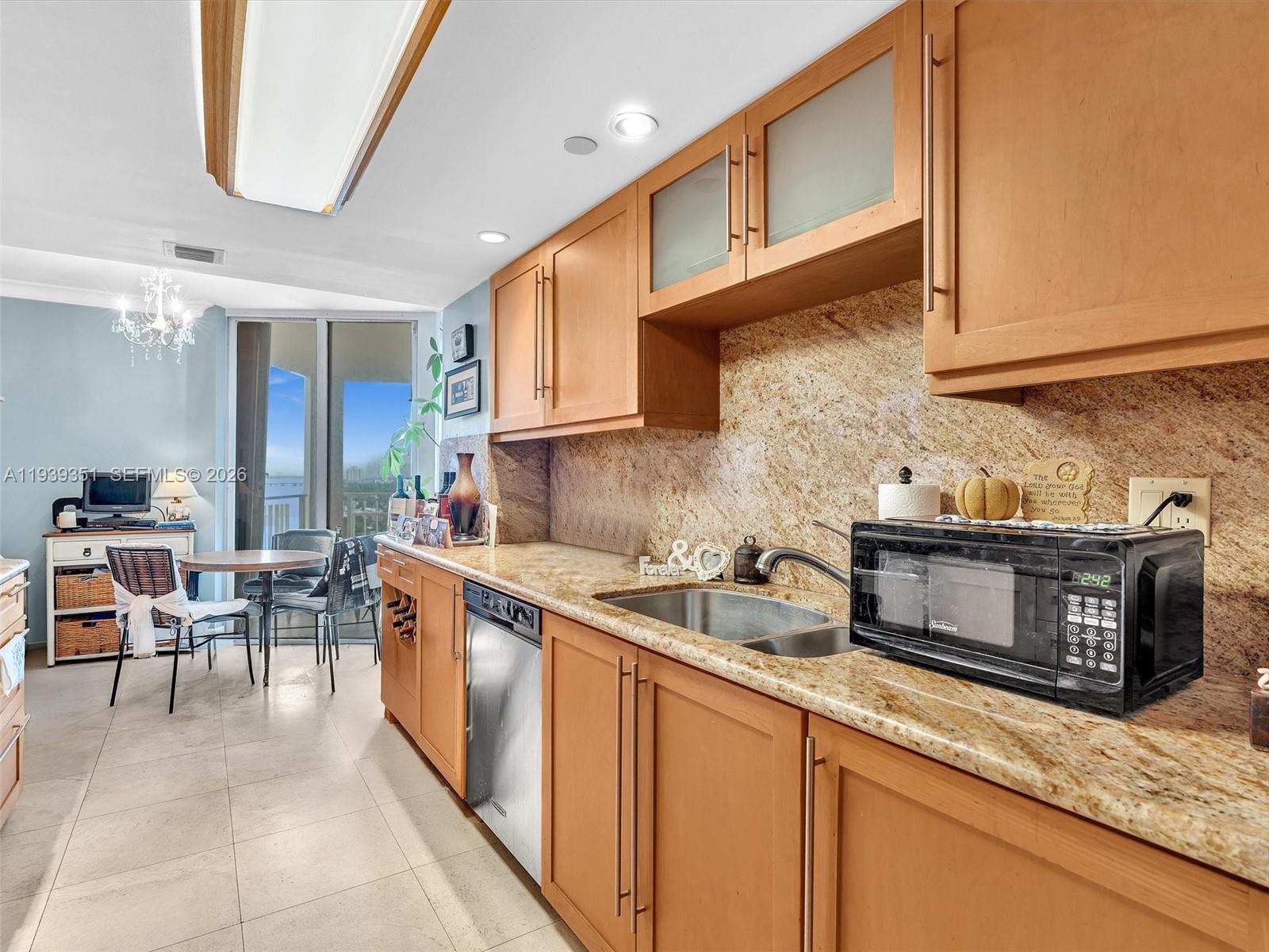 2000 Towerside Terrace, Unit 1806 Miami, FL 33138 - Photo 34 of 58 a kitchen with stainless steel appliances granite countertop a sink stove and cabinets