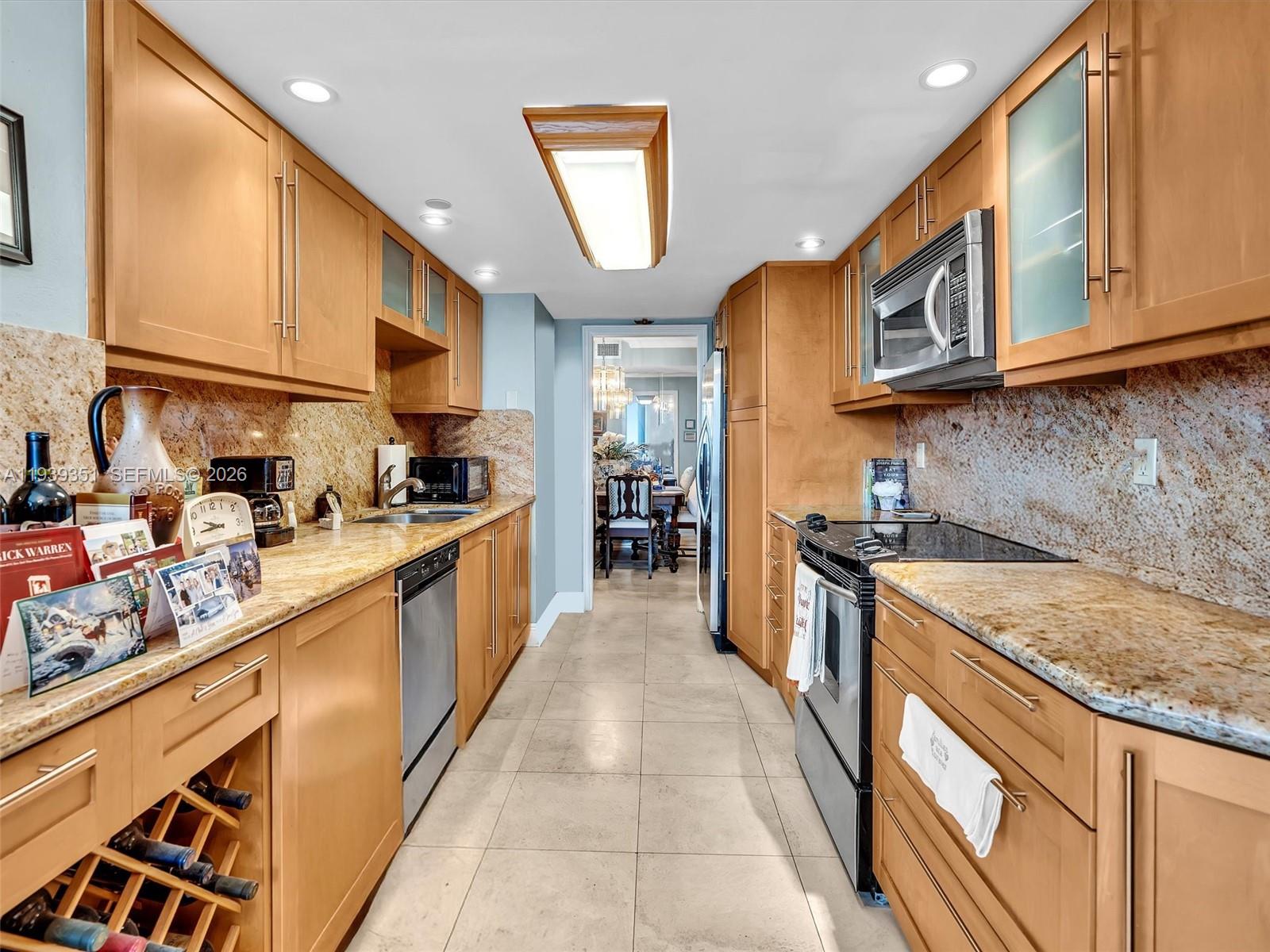 2000 Towerside Terrace, Unit 1806 Miami, FL 33138 - Photo 36 of 58 a large kitchen with stainless steel appliances granite countertop a stove a sink and a refrigerator