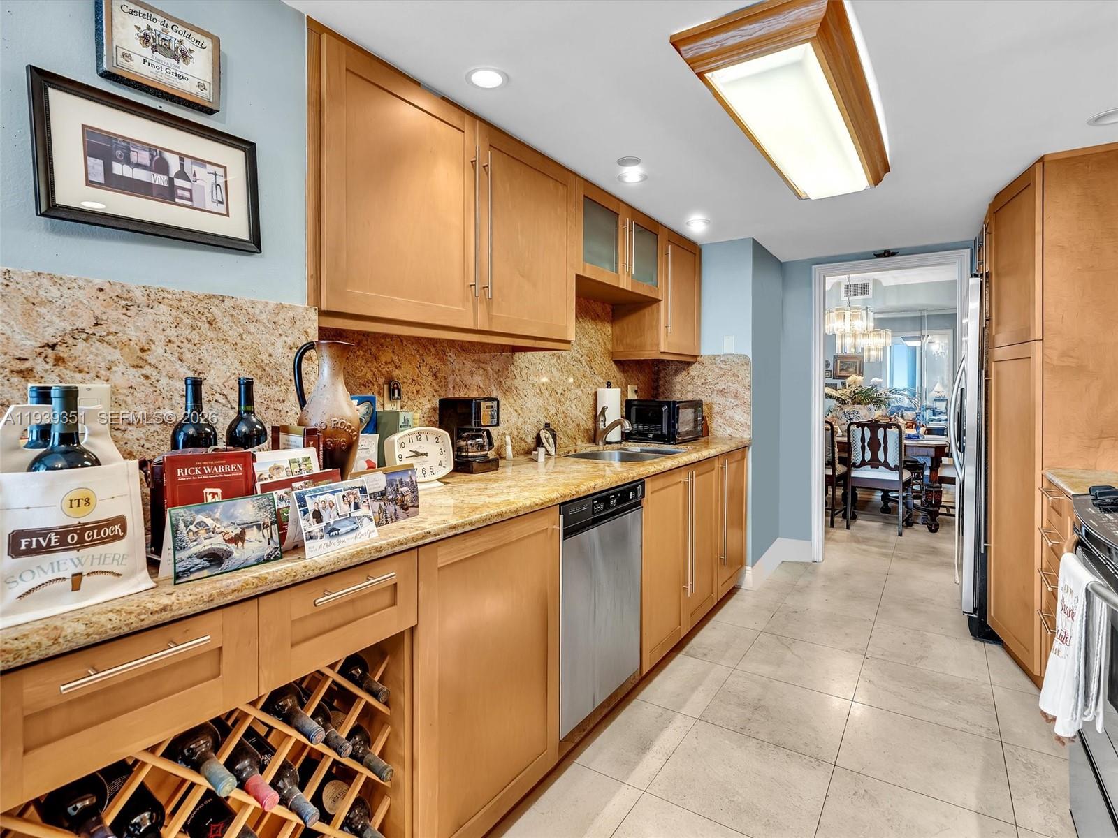 2000 Towerside Terrace, Unit 1806 Miami, FL 33138 - Photo 37 of 58 a kitchen with stainless steel appliances granite countertop a sink and cabinets
