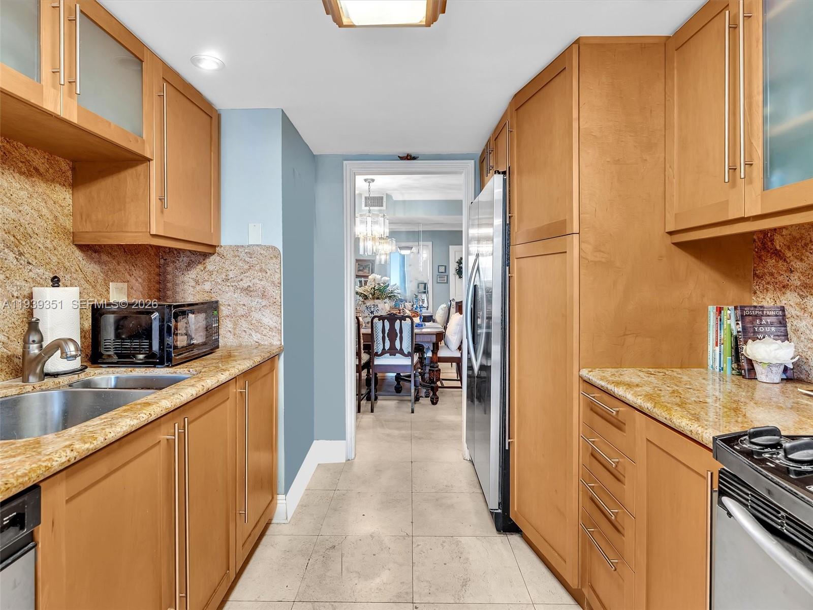 2000 Towerside Terrace, Unit 1806 Miami, FL 33138 - Photo 39 of 58 a kitchen with sink cabinets and appliances