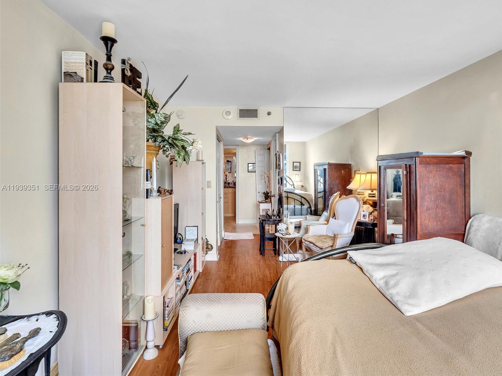 2000 Towerside Terrace, Unit 1806 Miami, FL 33138 - Photo 45 of 58 a bed room with a bed and a chandelier