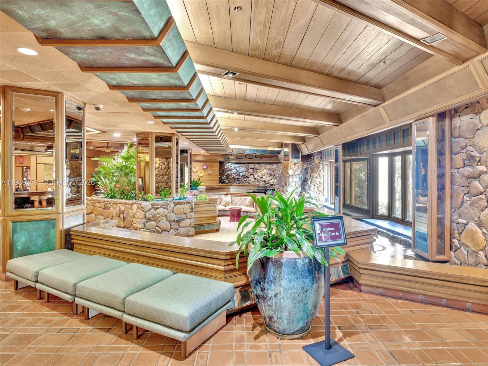 2000 Towerside Terrace, Unit 1806 Miami, FL 33138 - Photo 47 of 58 a living room with patio furniture and potted plants