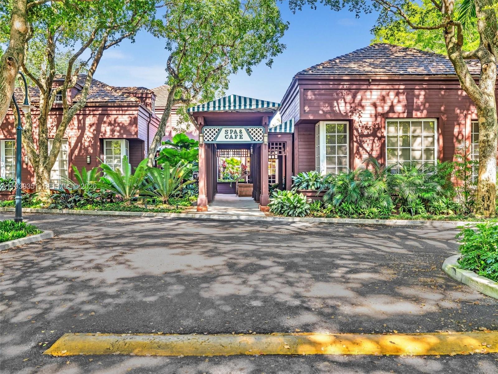2000 Towerside Terrace, Unit 1806 Miami, FL 33138 - Photo 48 of 58 a front view of a house with a garden and a yard