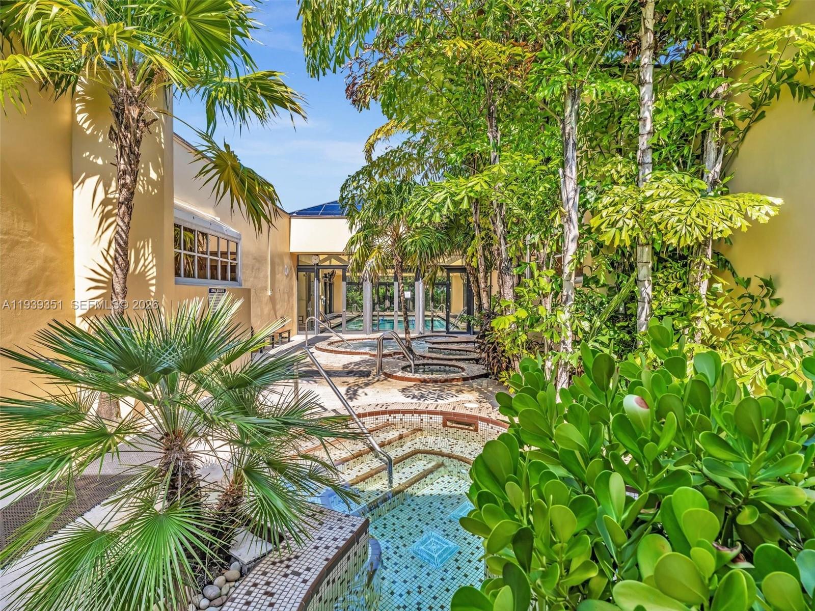 2000 Towerside Terrace, Unit 1806 Miami, FL 33138 - Photo 52 of 58 a view of backyard of house with outdoor seating and green space
