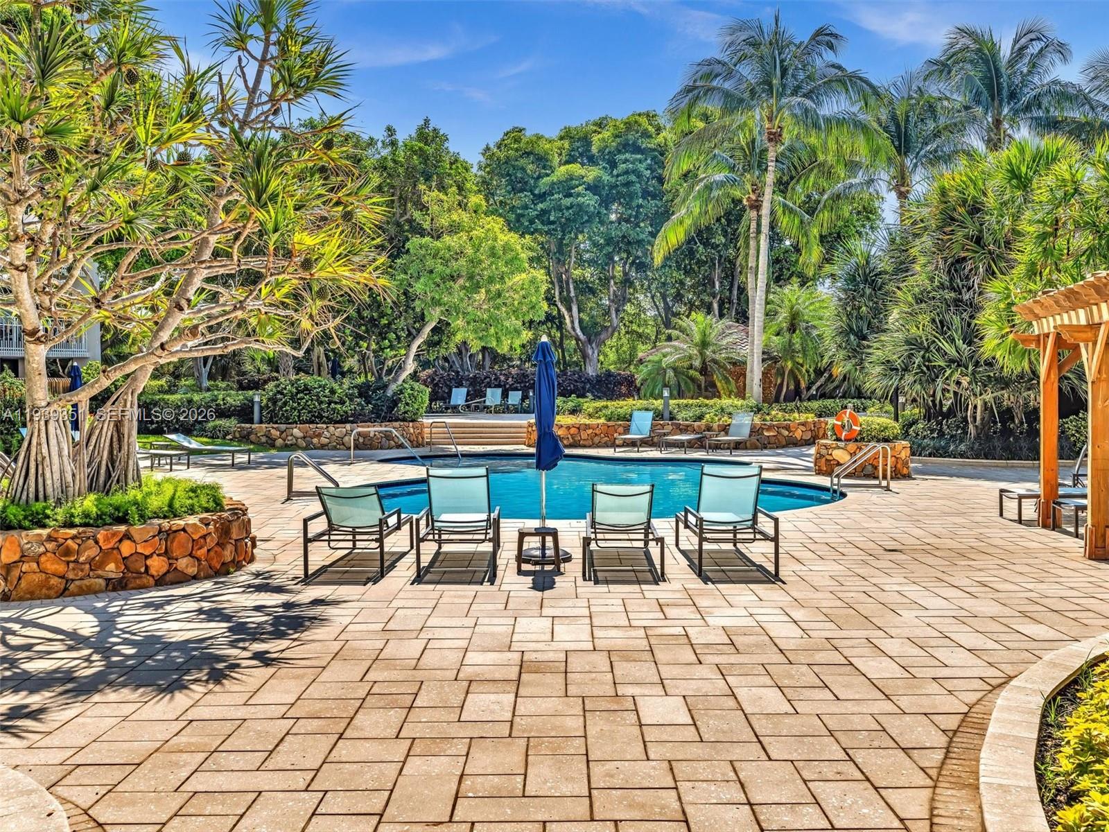 2000 Towerside Terrace, Unit 1806 Miami, FL 33138 - Photo 54 of 58 a lawn chairs sitting in a yard with swimming pool