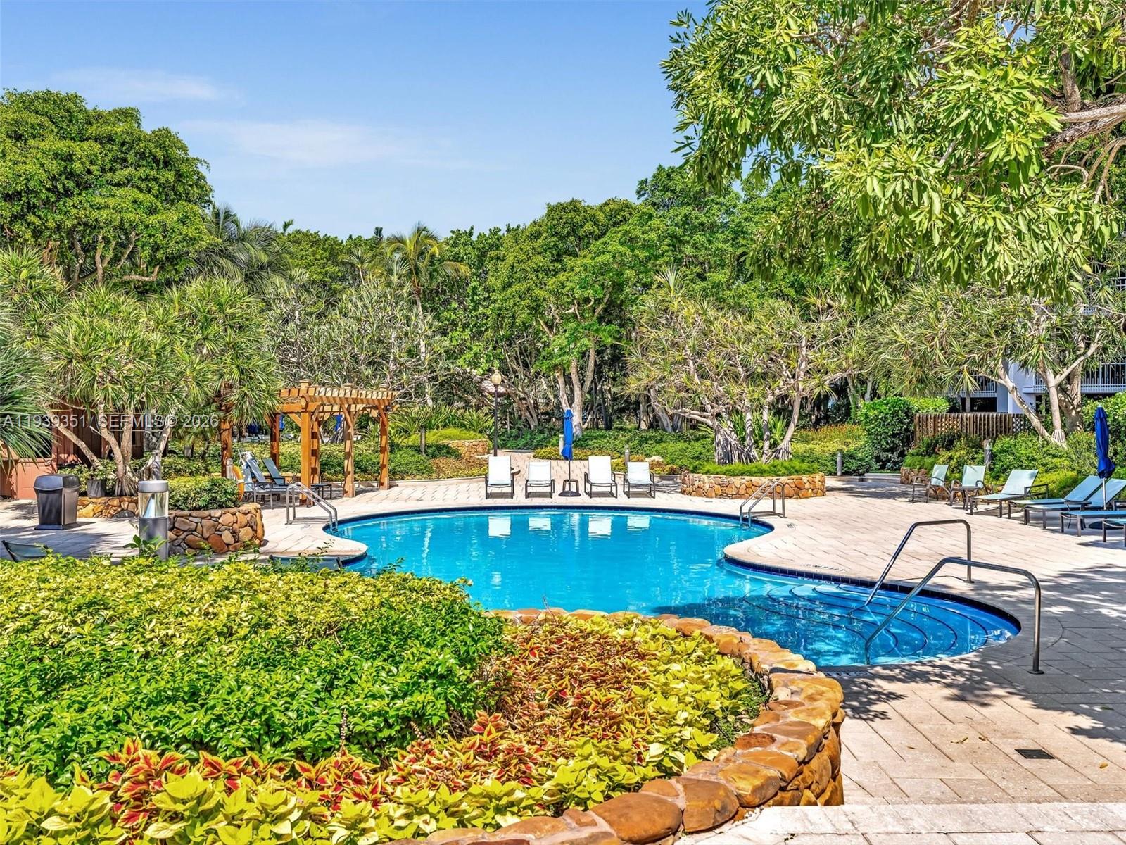 2000 Towerside Terrace, Unit 1806 Miami, FL 33138 - Photo 56 of 58 a view of a swimming pool with a patio