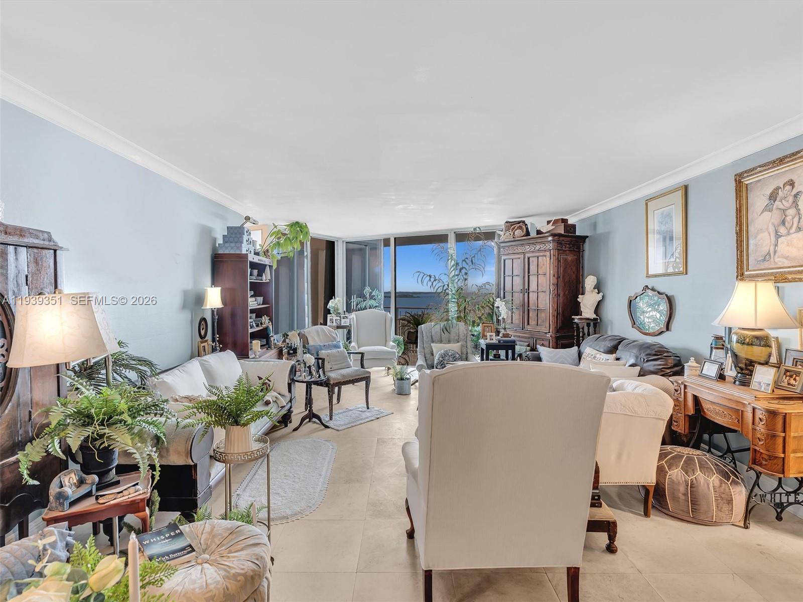 2000 Towerside Terrace, Unit 1806 Miami, FL 33138 - Photo 8 of 58 a living room with furniture a lamp a rug and a window