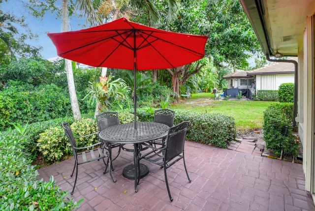 a front view of a house with yard and green space