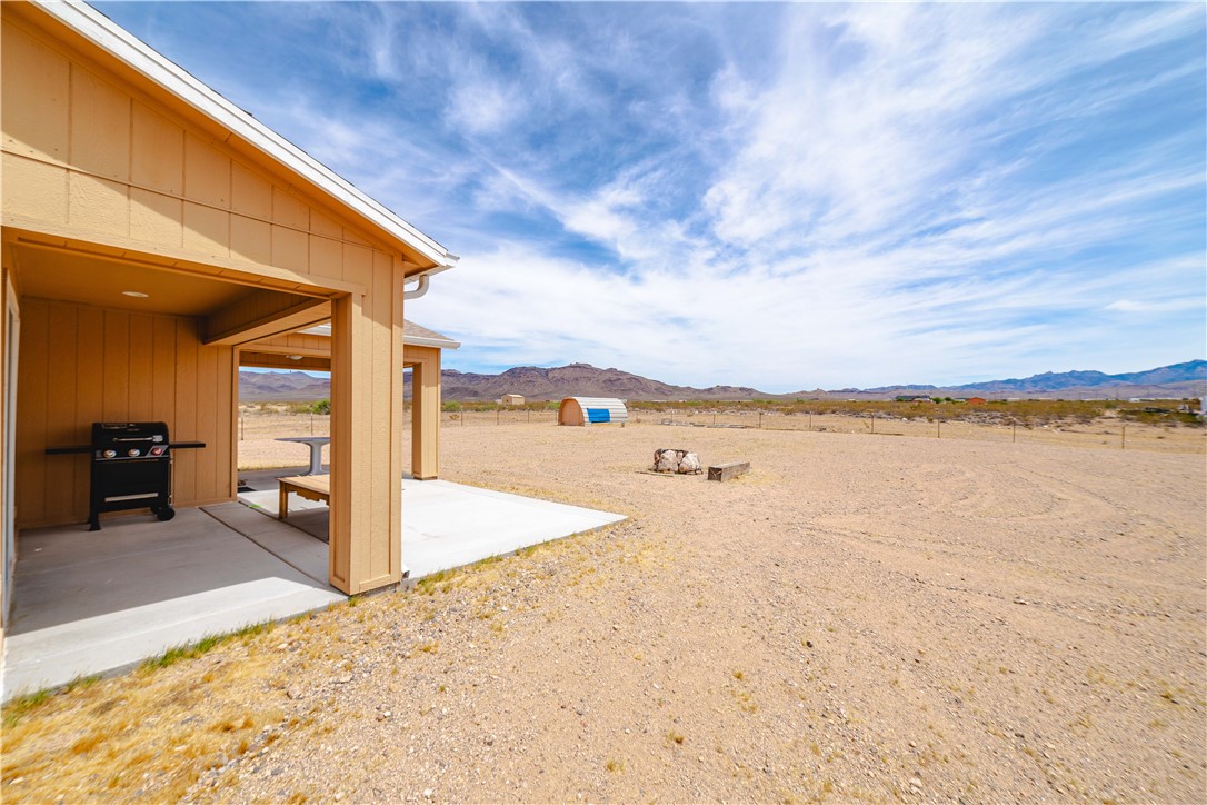 2948 Pinal Road Golden Valley, AZ 86413 - Photo 35 of 59 Covered concrete patio with recessed lighting and a large open yard