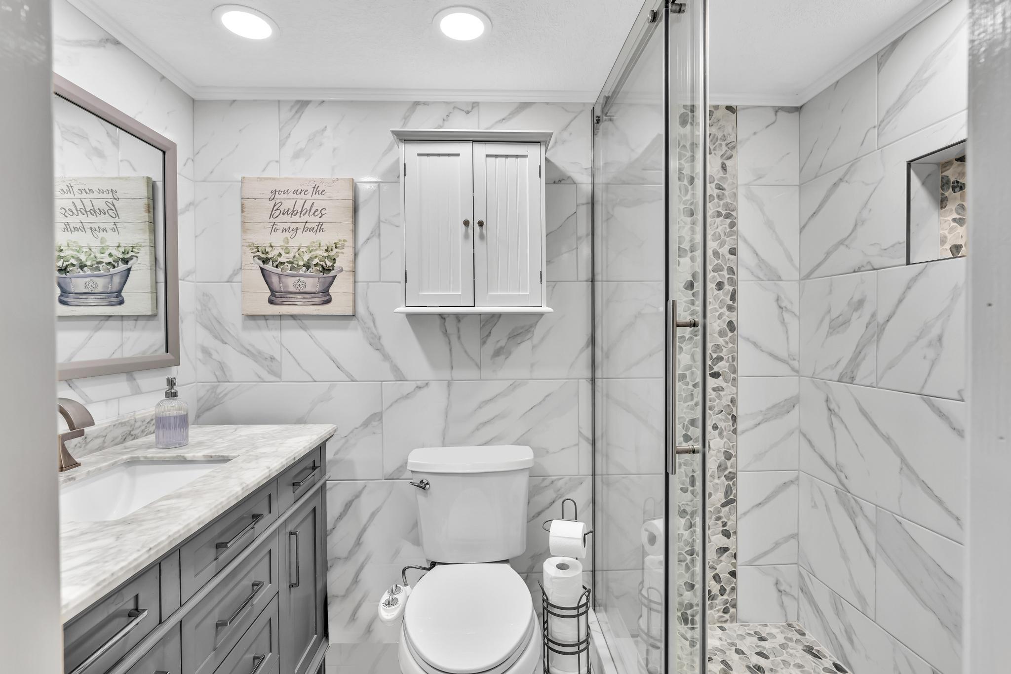 34 Colonial Club Drive, Unit 101 Boynton Beach, FL 33435 - Photo 21 of 58 a bathroom with a granite countertop sink toilet and shower