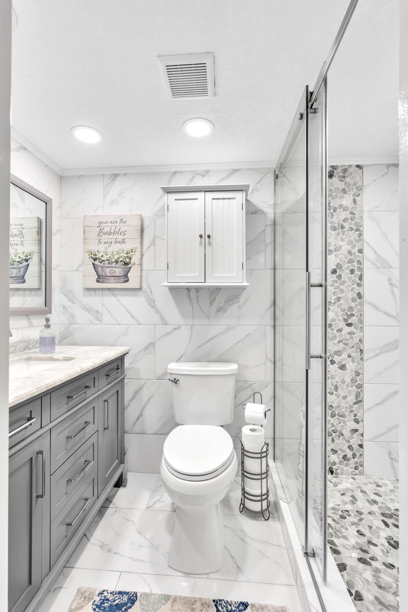 34 Colonial Club Drive, Unit 101 Boynton Beach, FL 33435 - Photo 22 of 58 PRIMARY BATHROOM & SHOWER