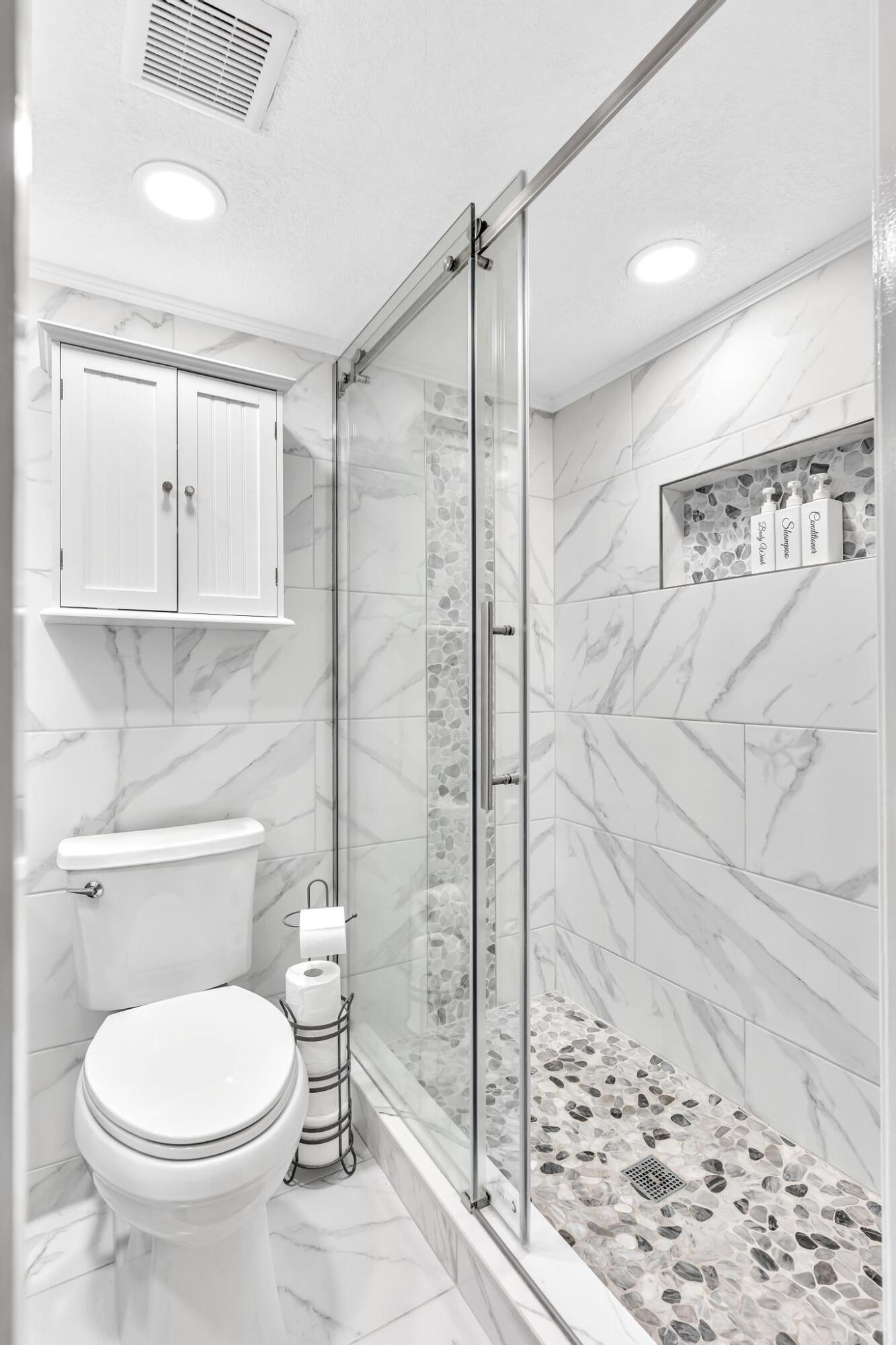 34 Colonial Club Drive, Unit 101 Boynton Beach, FL 33435 - Photo 23 of 58 a bathroom with a toilet and a shower