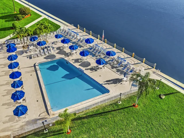 a view of swimming pool with outdoor seating and yard in back