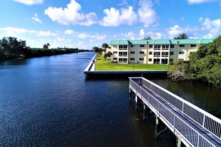 34 Colonial Club Drive, Unit 101 Boynton Beach, FL 33435 - Photo 47 of 58 a view of swimming pool with outdoor seating and yard in back