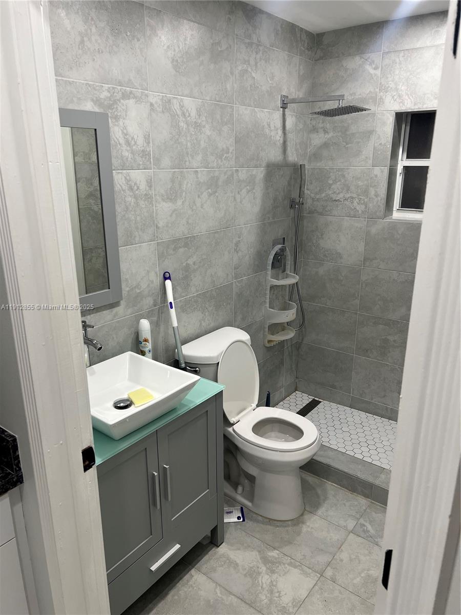 14364 Southwest 159th Terrace Miami, FL 33177 - Photo 4 of 7 a bathroom with a toilet sink and mirror