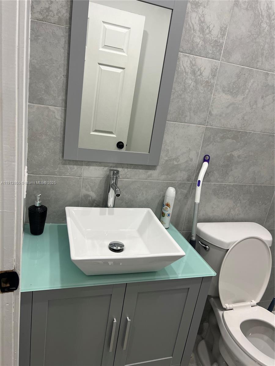 14364 Southwest 159th Terrace Miami, FL 33177 - Photo 7 of 7 a bathroom with a sink a toilet and mirror