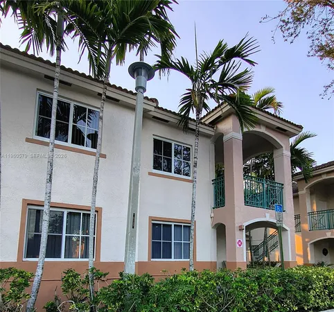 front view of a house with a palm tree