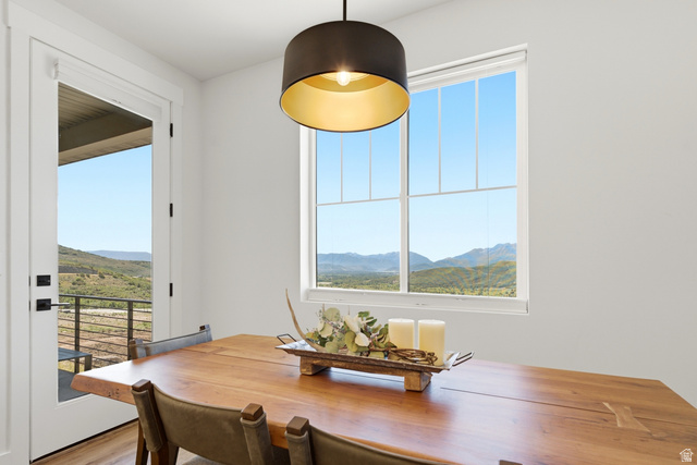 6039 North Westridge Road Heber City, UT 84032 - Photo 15 of 71 Expansive window with mountain scenery, direct outdoor access, and a dark-toned pendant light fixture