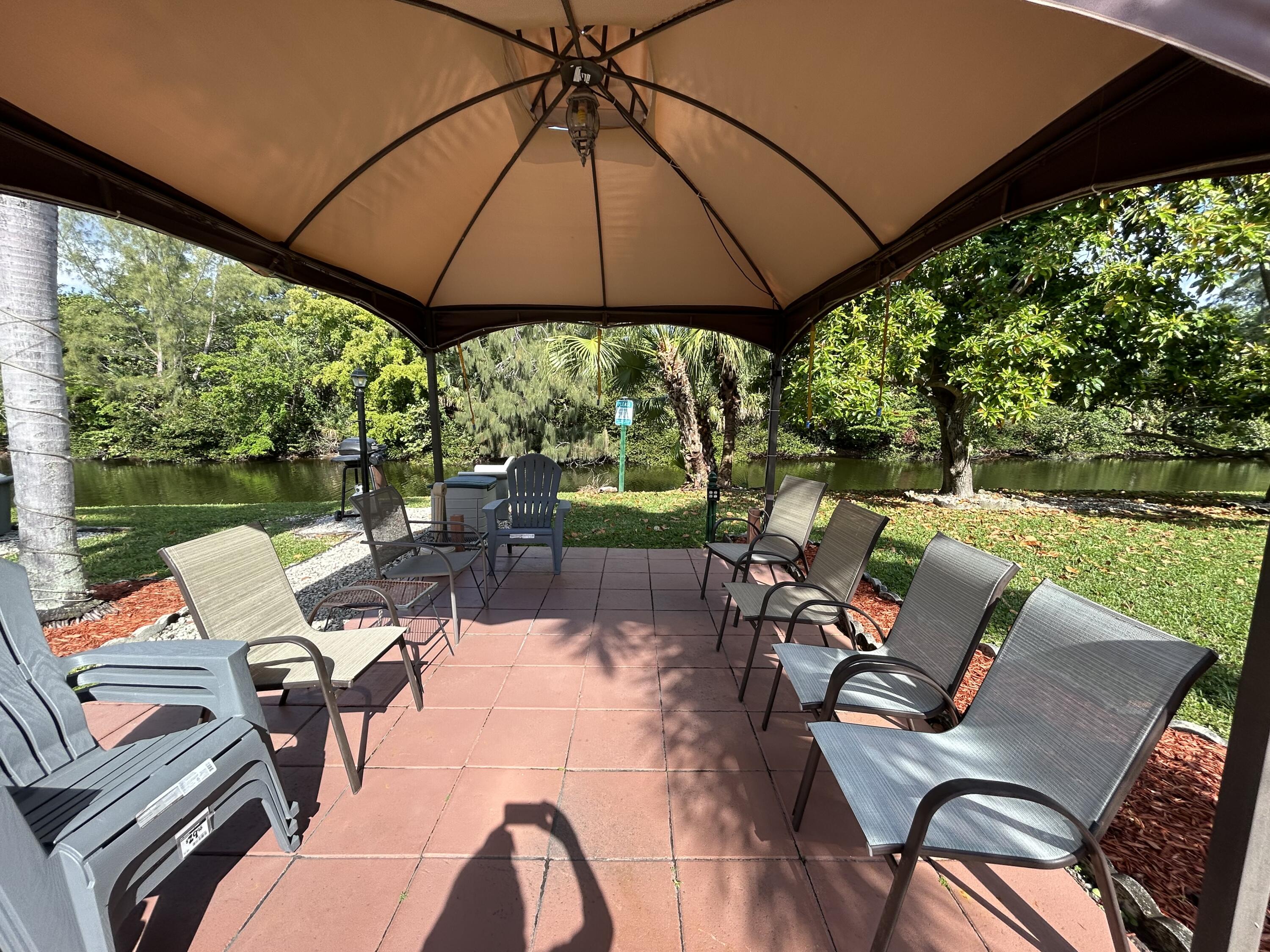 a view of a patio with a table chairs and a umbrella