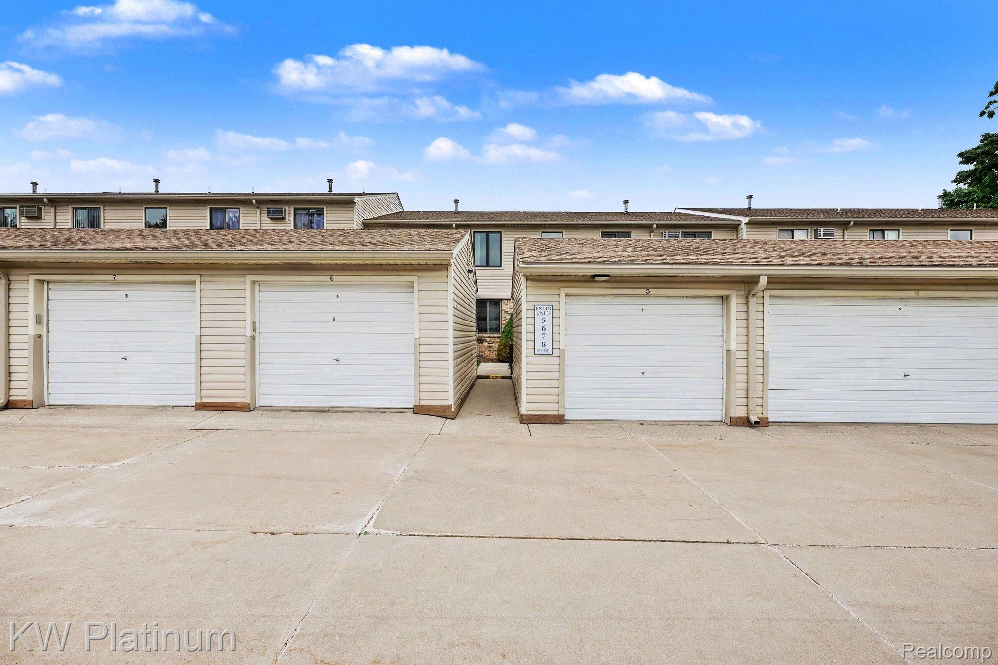 1700 River Road, Unit 6 Marysville, MI 48040 - Photo 23 of 32 Multiple garages with white paneled doors under a shingled roofline